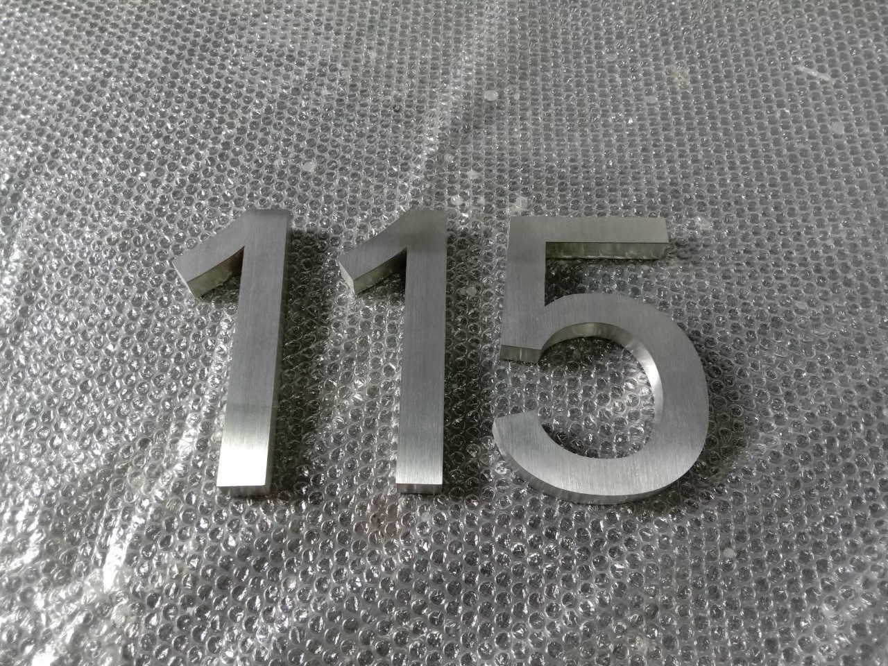 งานป้ายบ้านเลขที่ 115