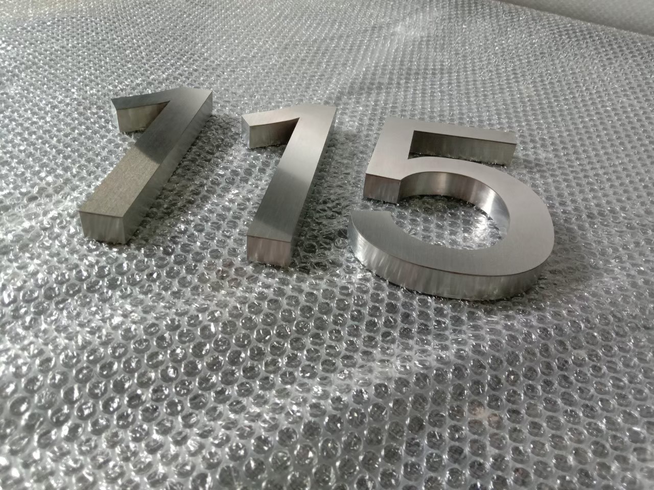 งานป้ายบ้านเลขที่ 115