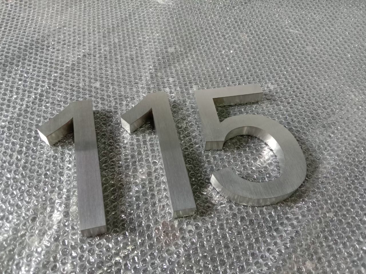 งานป้ายบ้านเลขที่ 115